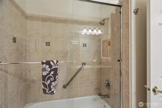 a bathroom with a shower and a mirror