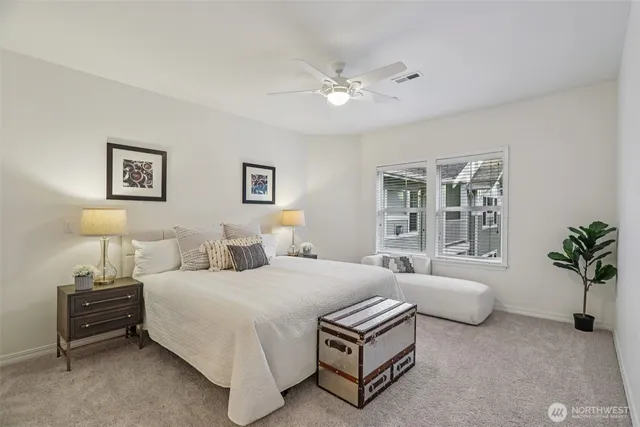 a bedroom with a bed and a potted plant