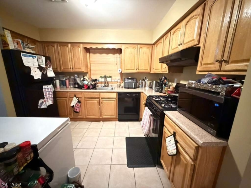 a kitchen with a stove a refrigerator and a sink