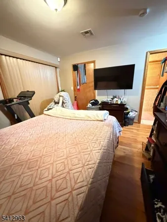 a bedroom with two beds and a flat screen tv