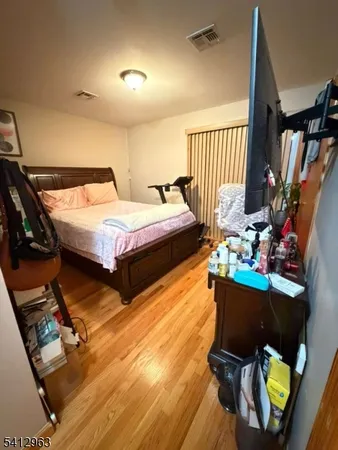 a bedroom with bed and a window