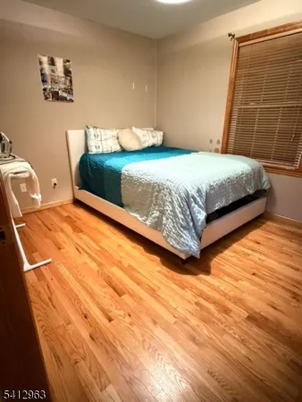 a bedroom with a bed and wall painting