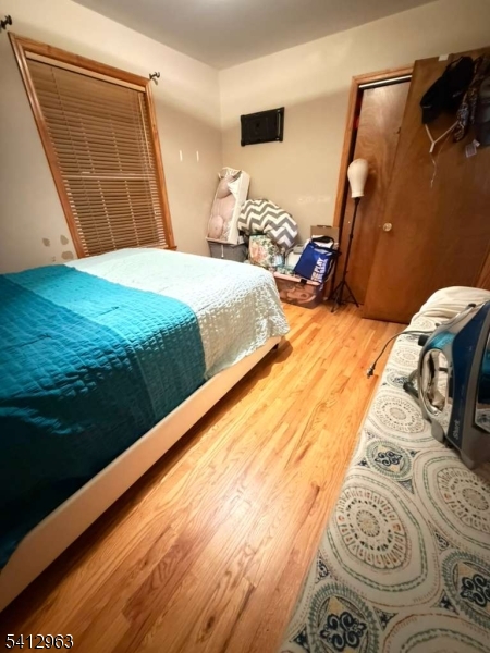 328 High Street, Unit 2 Elizabeth, NJ 07202 - Photo 5 of 13 a bedroom with a bed and wooden floor