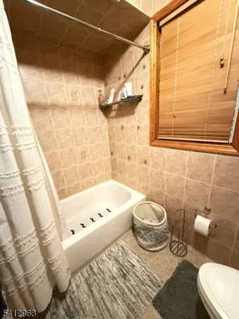 a bathroom with a sink a toilet and bathtub