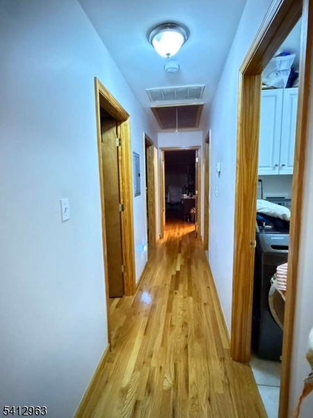 328 High Street, Unit 2 Elizabeth, NJ 07202 - Photo 8 of 13 a view of a hallway with wooden floor and a chandelier