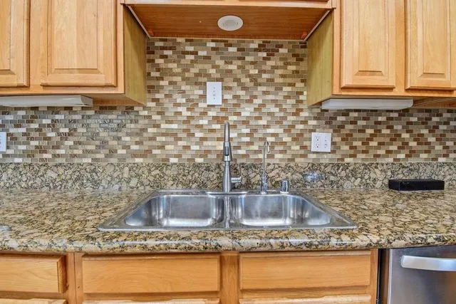 a view of a patio with couches table and chairs and potted plants