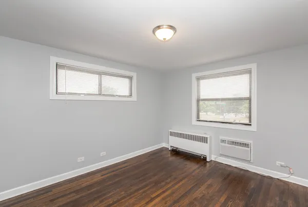 a view of room with window and wooden floor