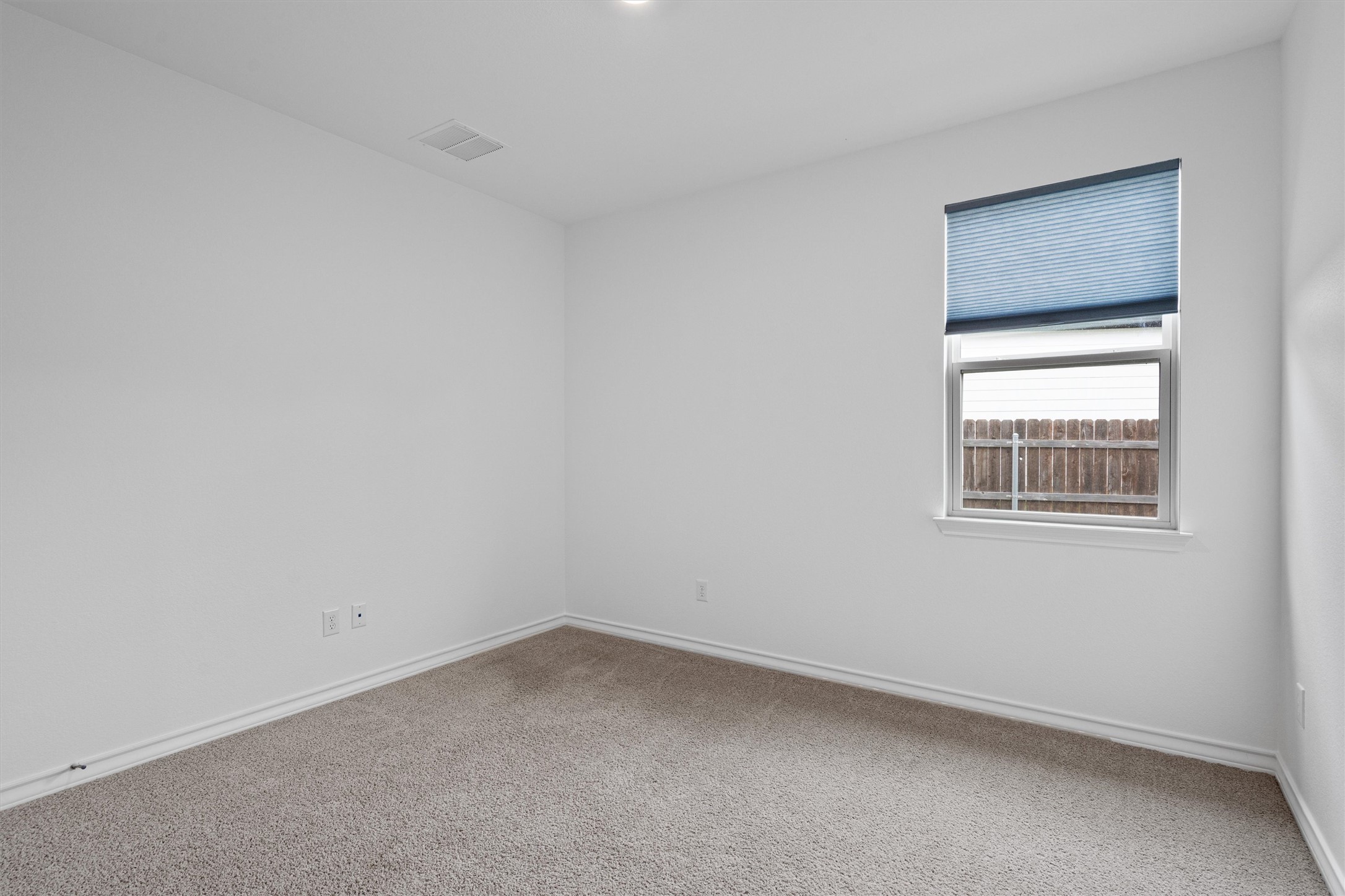 104 Stinchcomb Road Hutto, TX 78634 - Photo 27 of 40 Bedroom 4 is located down the hall near the center of the home, offering added flexibility and privacy. Positioned near the half bath, it would make a perfect home office, guest room, or flex space.