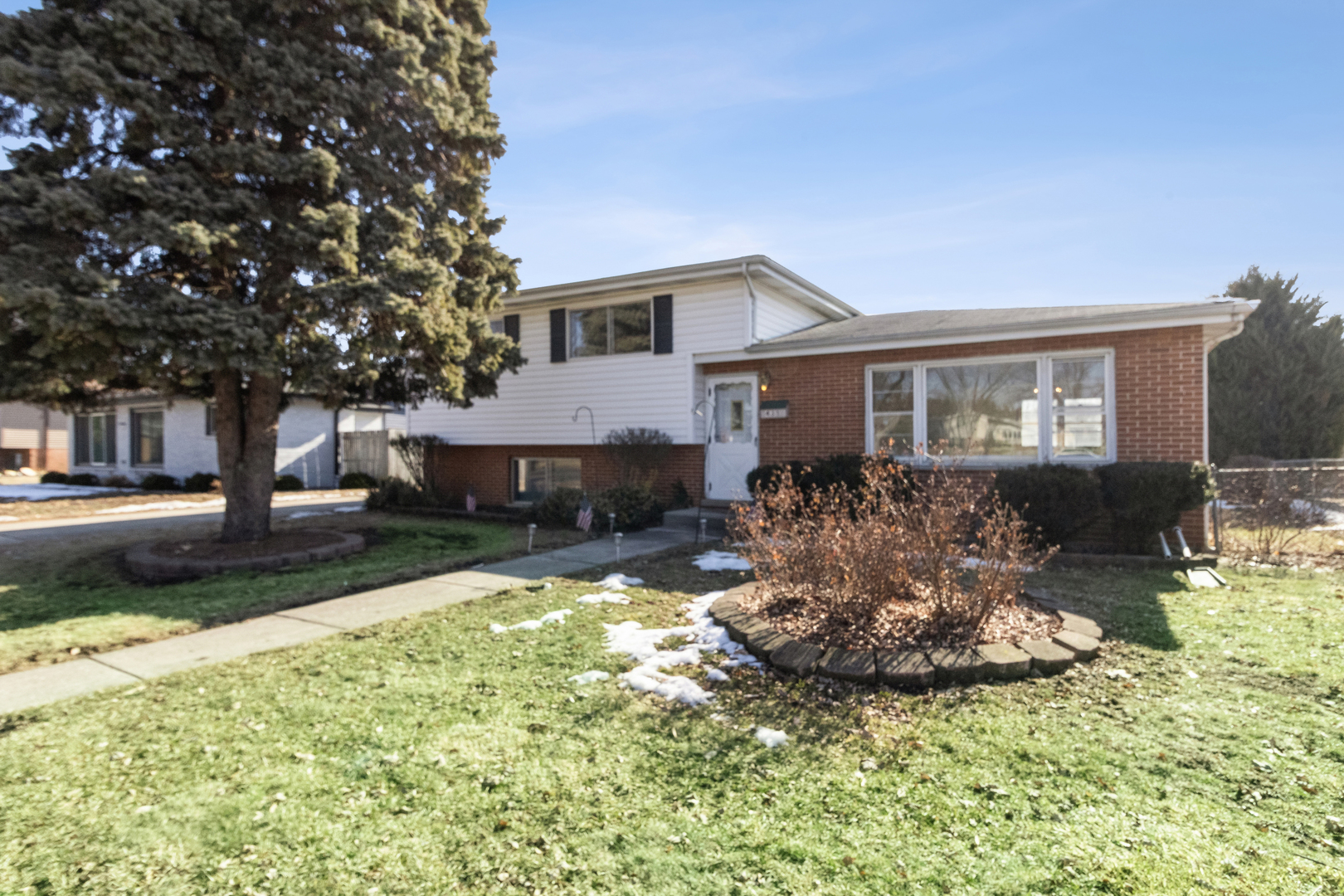 a front view of a house with a yard garage and outdoor seating