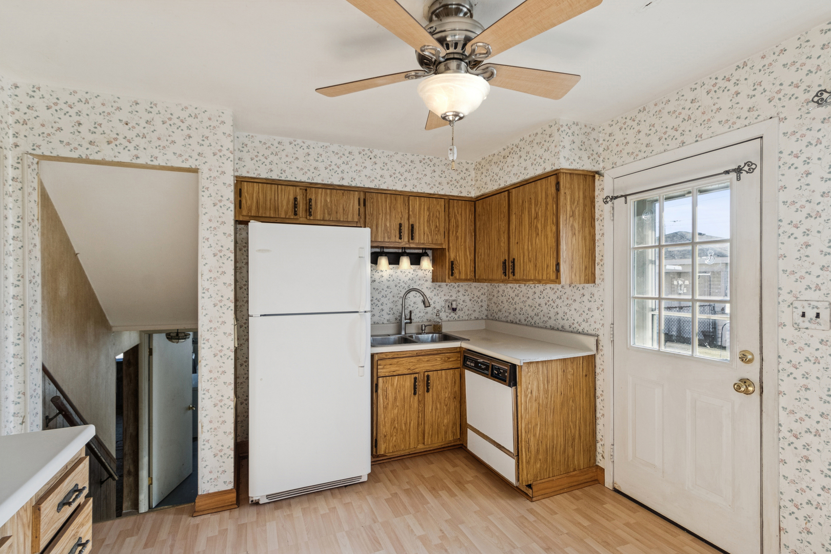 431 Ardmore Terrace Addison, IL 60101 - Photo 3 of 15 a kitchen with a refrigerator a stove cabinets and wooden floor
