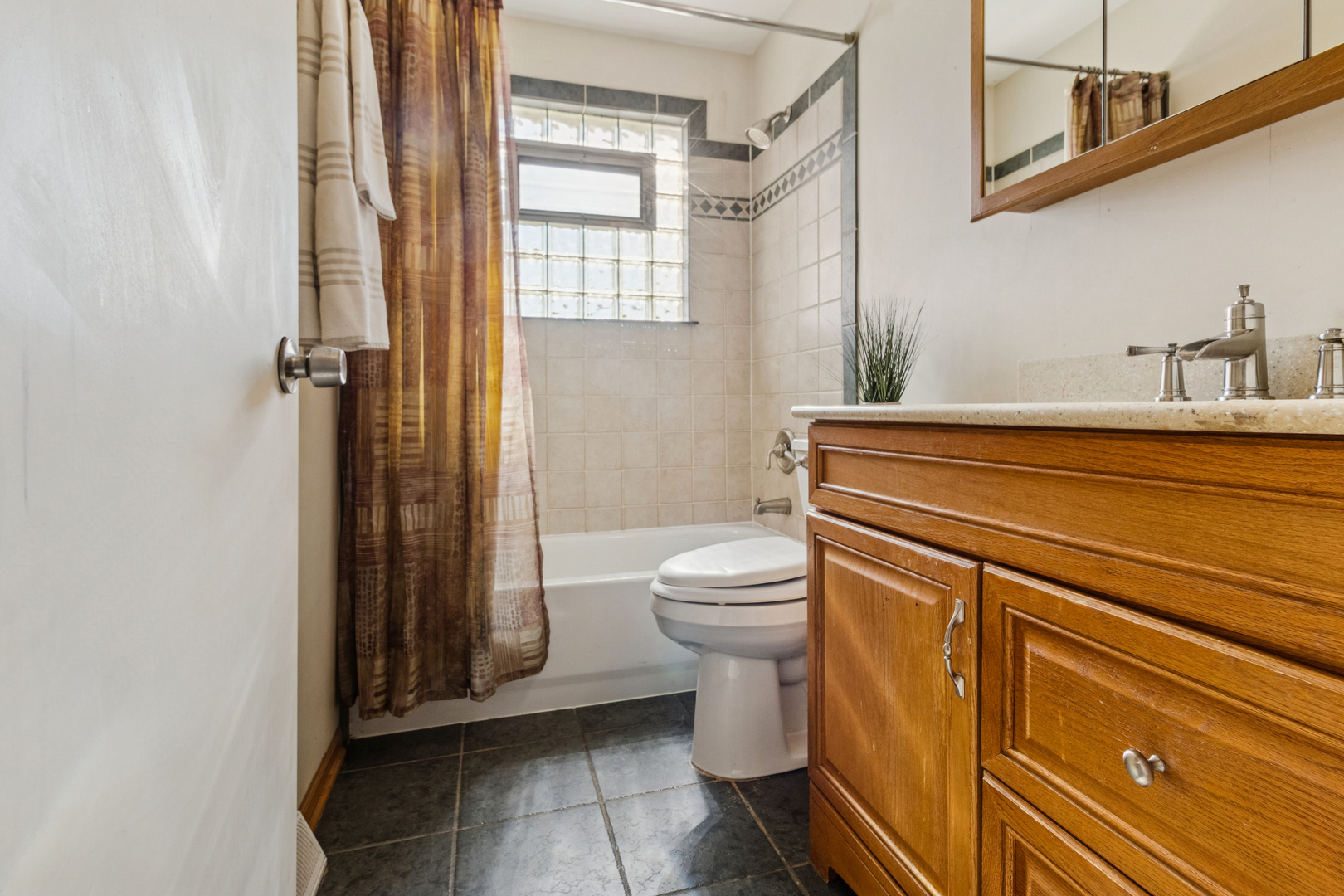 431 Ardmore Terrace Addison, IL 60101 - Photo 7 of 15 a bathroom with a sink a toilet and shower