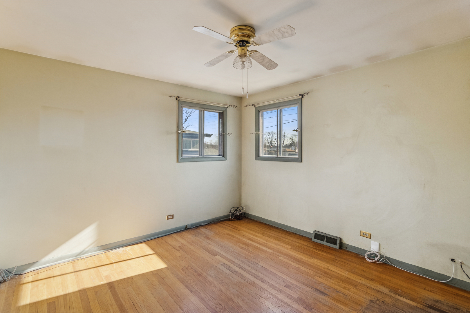 431 Ardmore Terrace Addison, IL 60101 - Photo 8 of 15 an empty room with a chandelier fan and windows