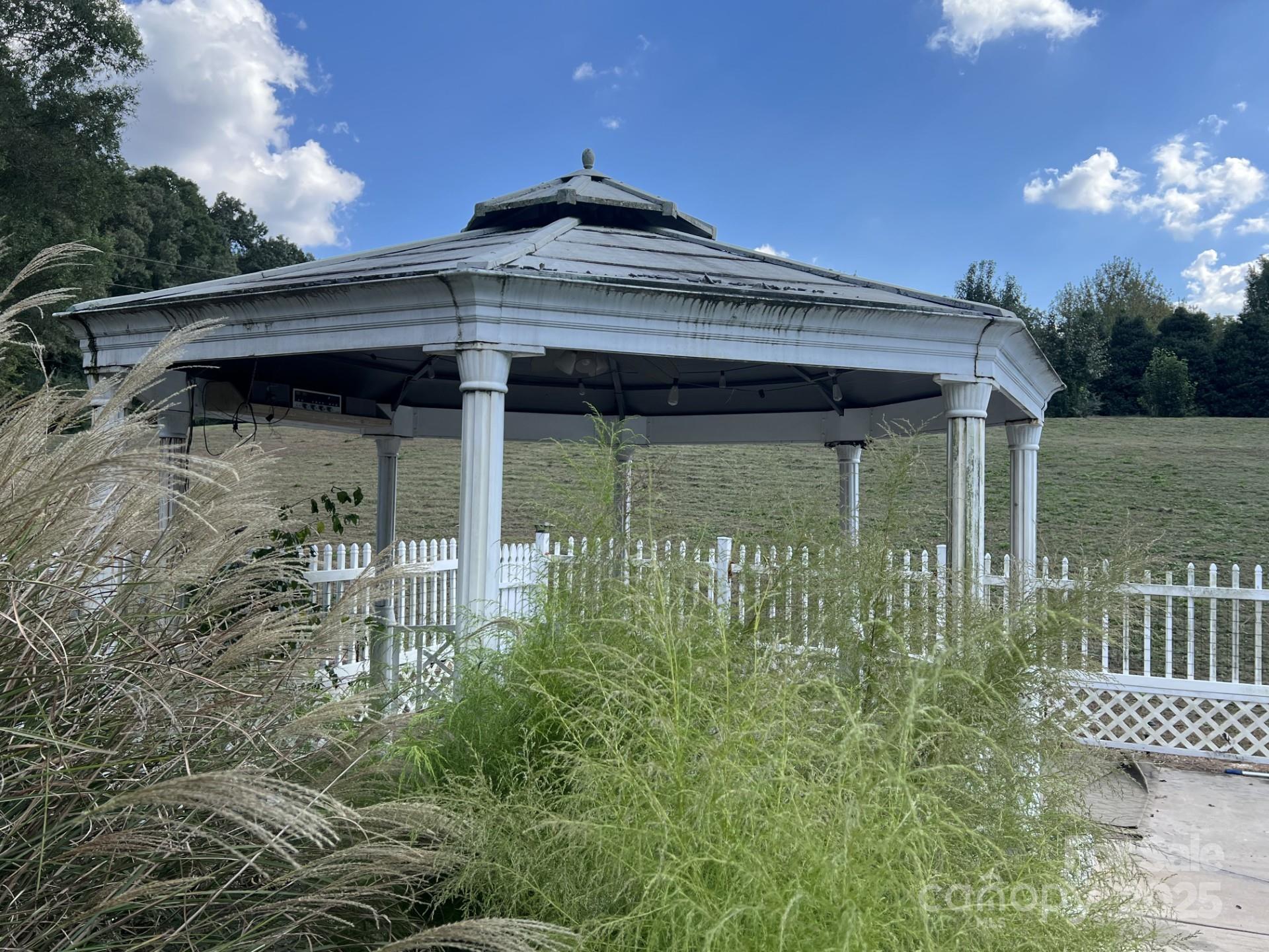 331 Polk Ford Road Stanfield, NC 28163 - Photo 33 of 33 a view of a wooden house with a yard