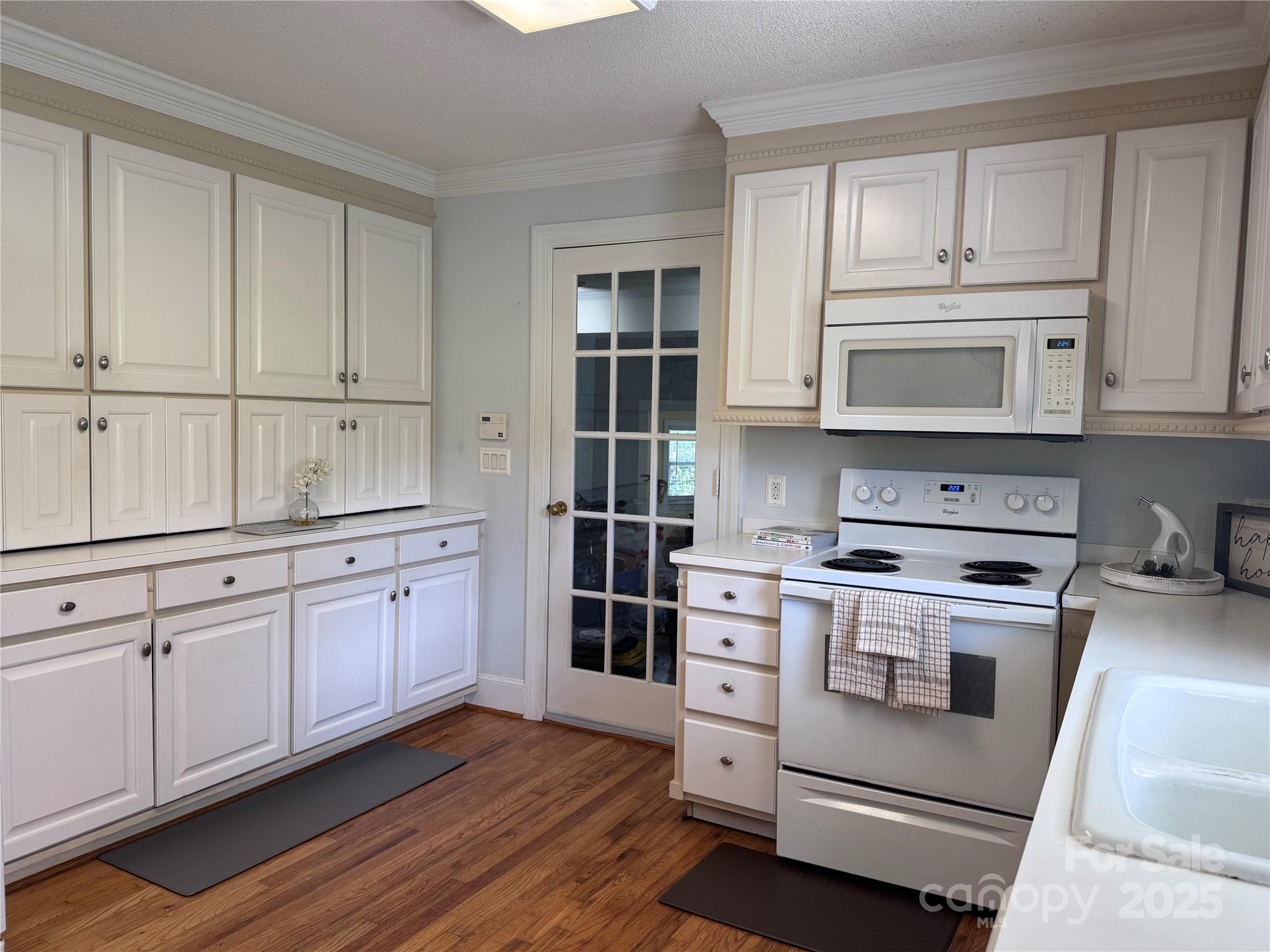 331 Polk Ford Road Stanfield, NC 28163 - Photo 8 of 33 a kitchen with granite countertop white cabinets and stainless steel appliances