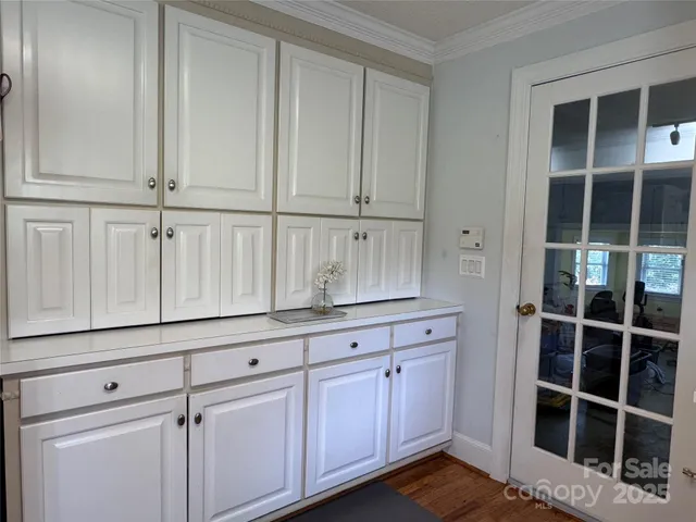 a kitchen with granite countertop white cabinets and sink