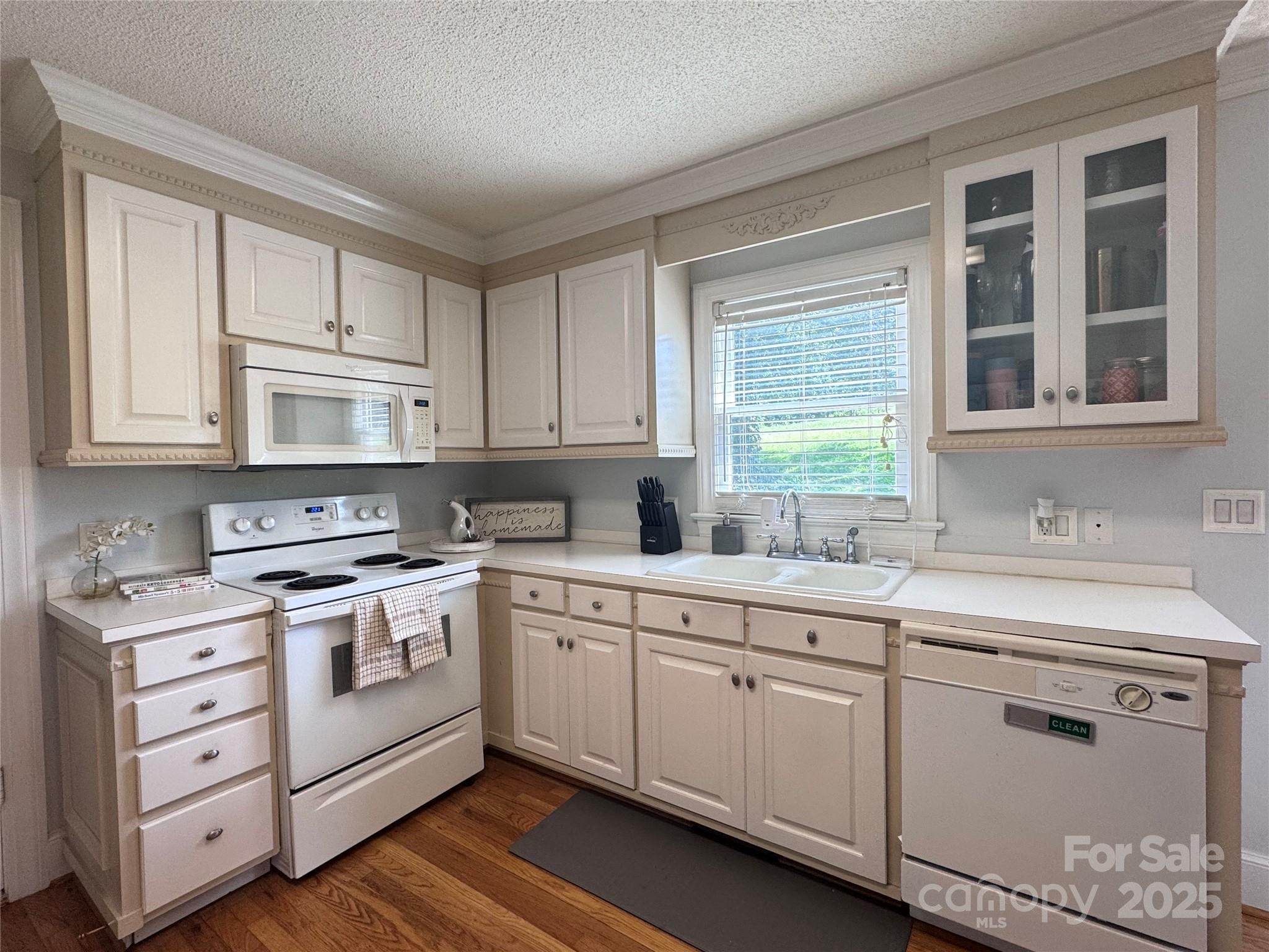 331 Polk Ford Road Stanfield, NC 28163 - Photo 10 of 33 a kitchen with white cabinets appliances a sink and a window