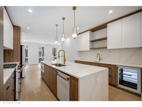a kitchen with stainless steel appliances a sink stove and cabinets