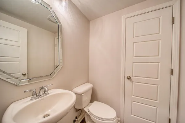 a view of an empty room with closet and a window