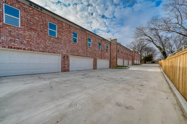 front view of a brick house with a yard