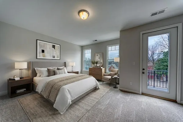 a bedroom with a bed and a large window