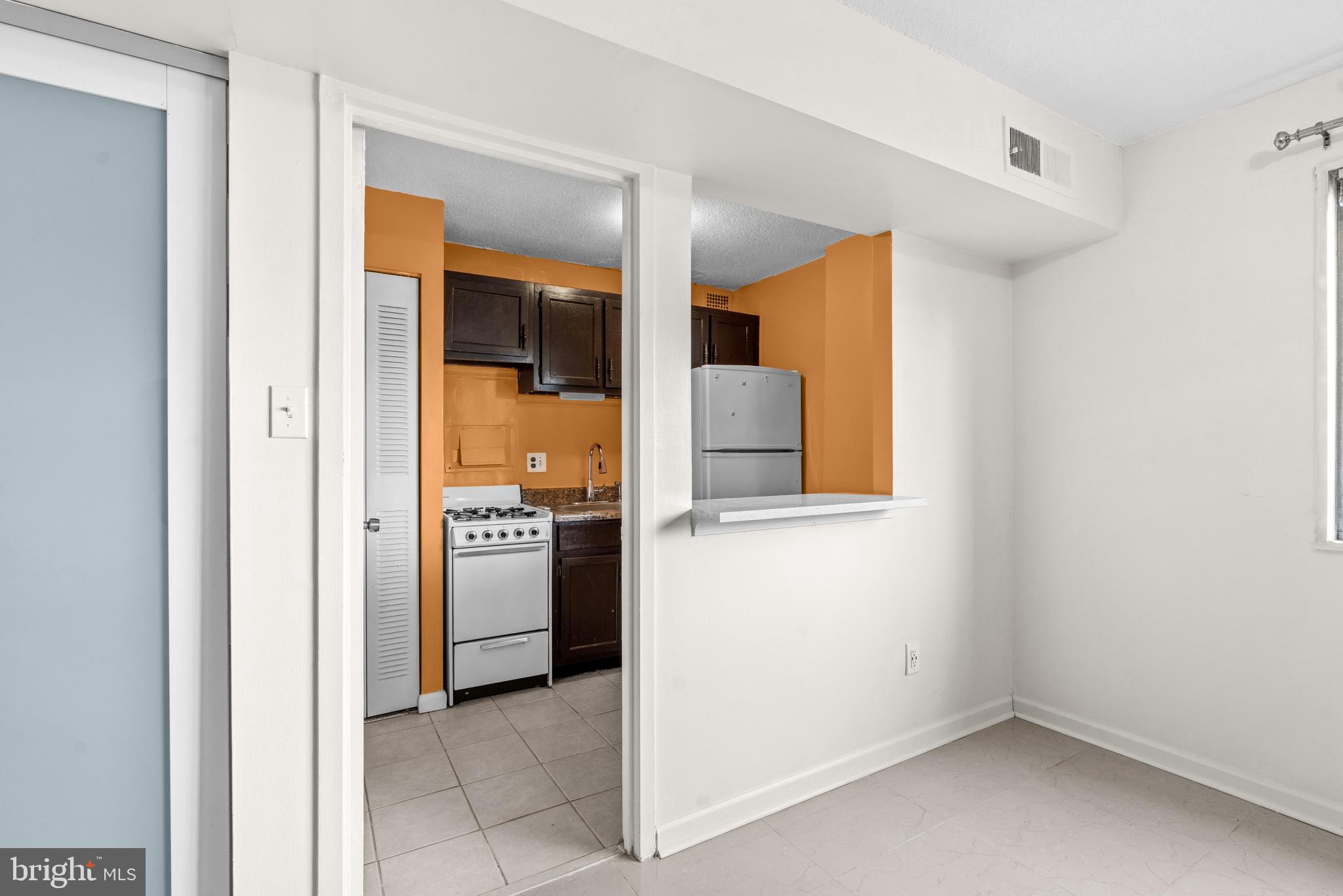 1836 Metzerott Road, Unit 215 Hyattsville, MD 20783 - Photo 22 of 36 a kitchen with a refrigerator and a stove