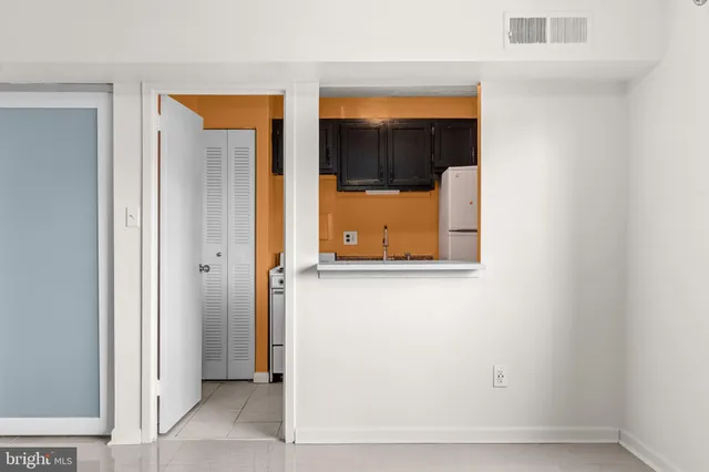 a view of an empty room with glass door