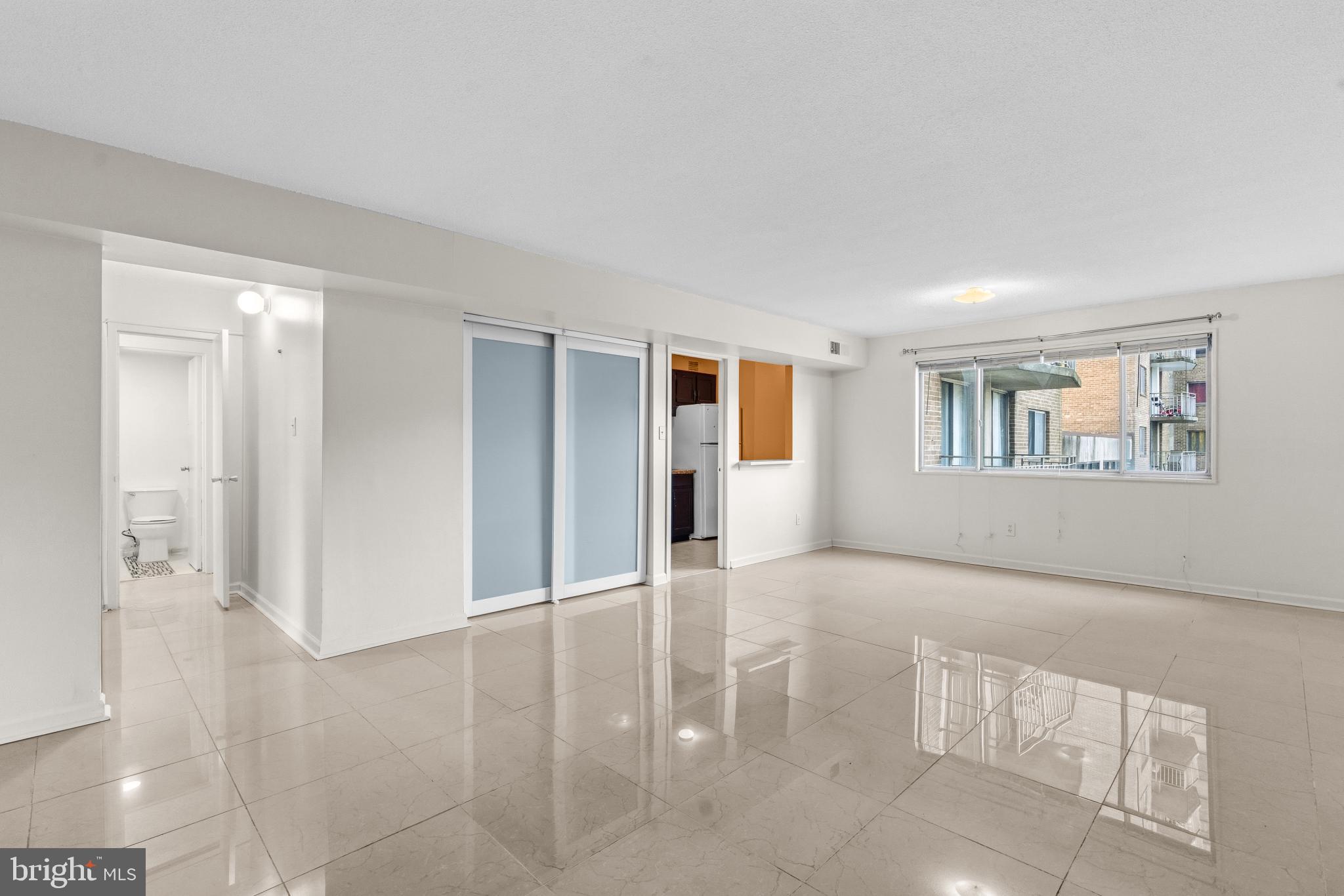 1836 Metzerott Road, Unit 215 Hyattsville, MD 20783 - Photo 26 of 36 a view of an empty room with glass door