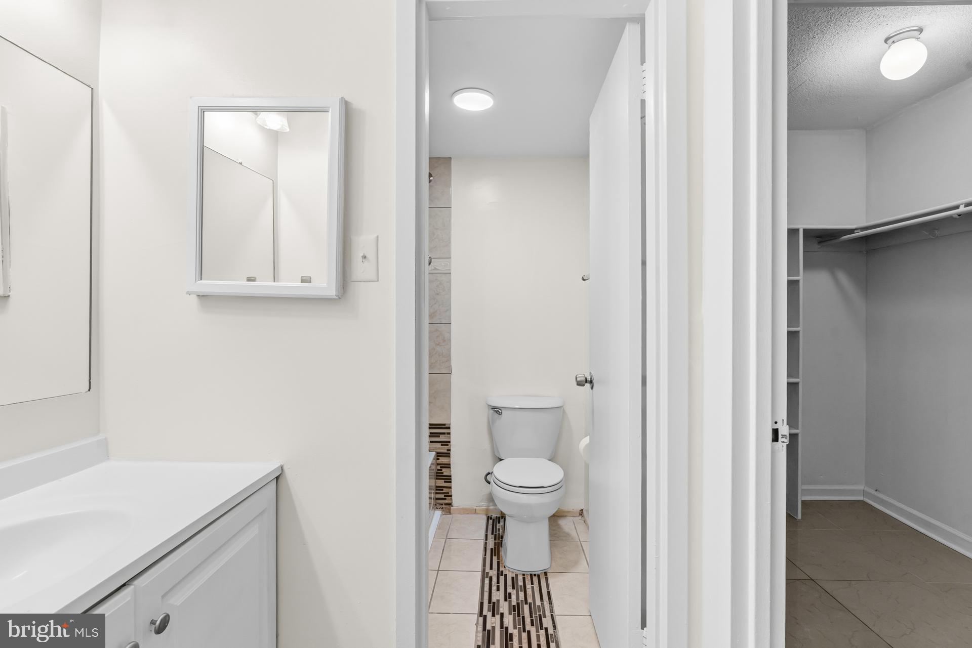 1836 Metzerott Road, Unit 215 Hyattsville, MD 20783 - Photo 28 of 36 a bathroom with a sink a toilet and a mirror