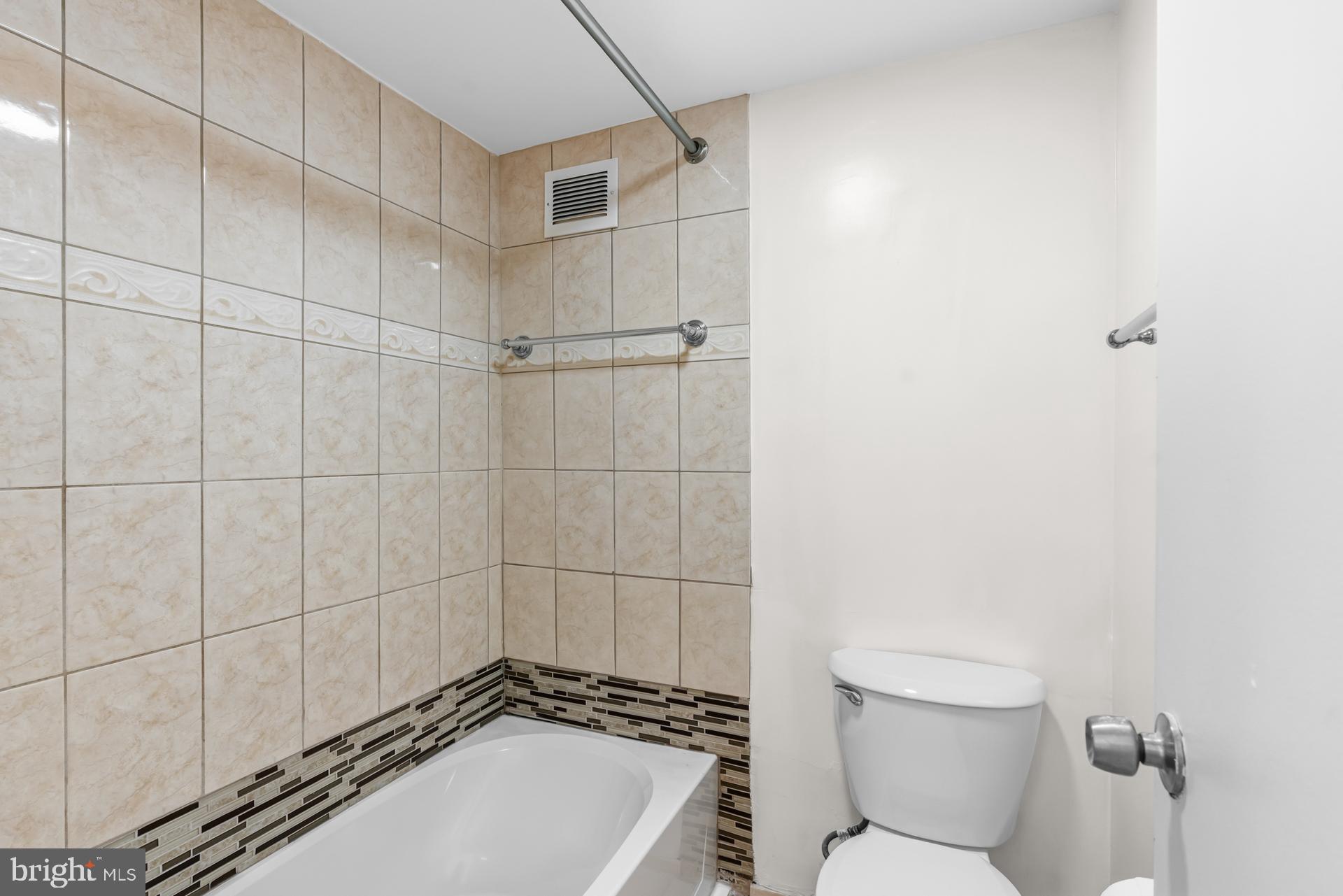 1836 Metzerott Road, Unit 215 Hyattsville, MD 20783 - Photo 30 of 36 a bathroom with a toilet and shower