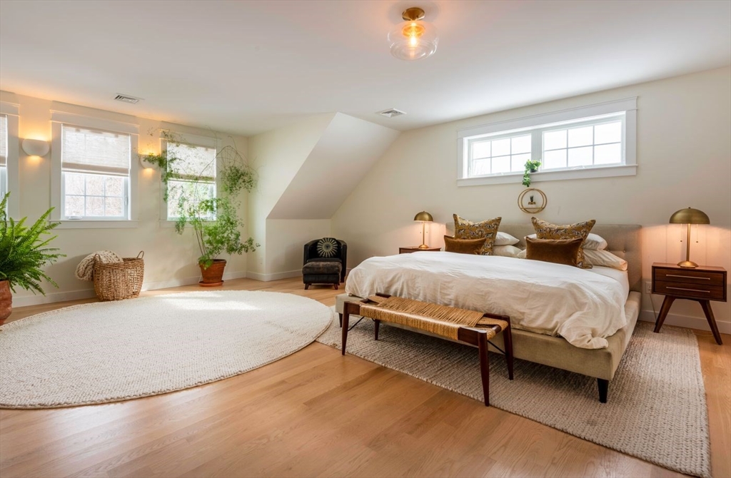 5 John West Road Exeter, NH 03833 - Photo 15 of 33 a bedroom with bed and a potted plant