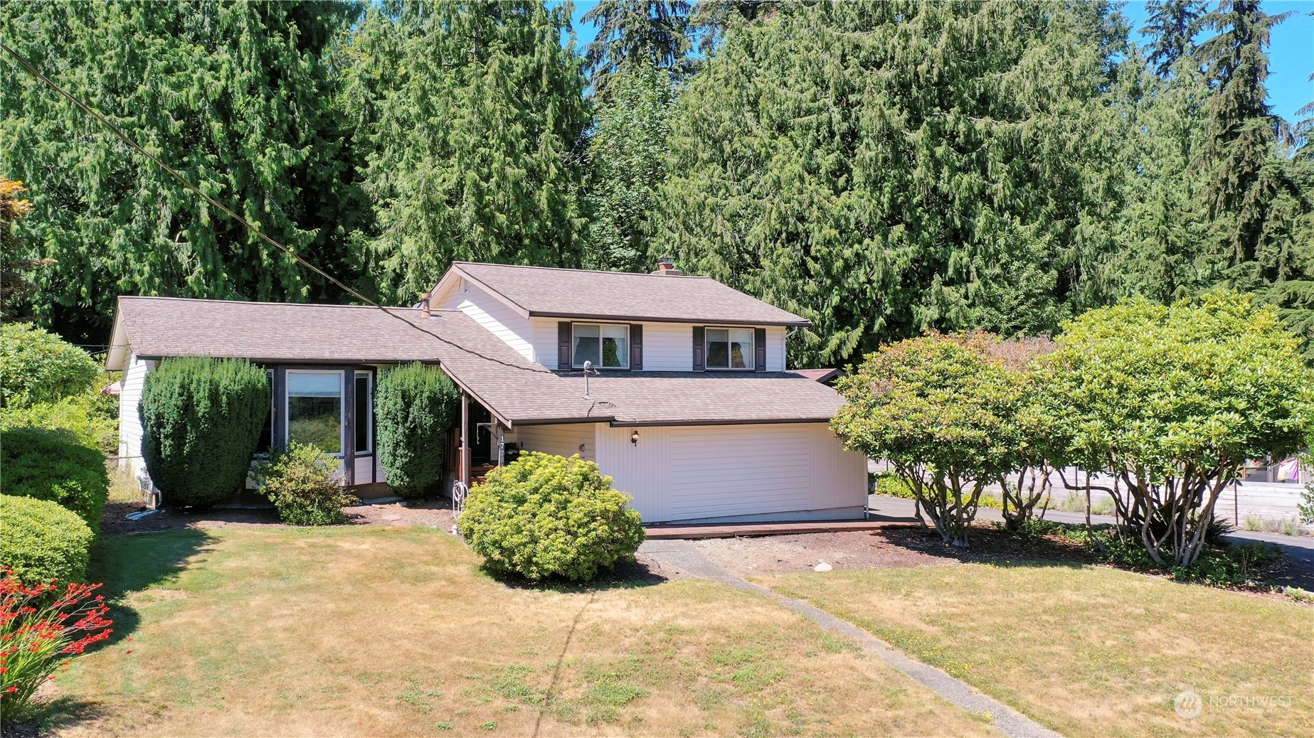 17204 Gravenstein Road Bothell, WA 98012 - Photo 1 of 38 a view of a house with a yard and potted plants
