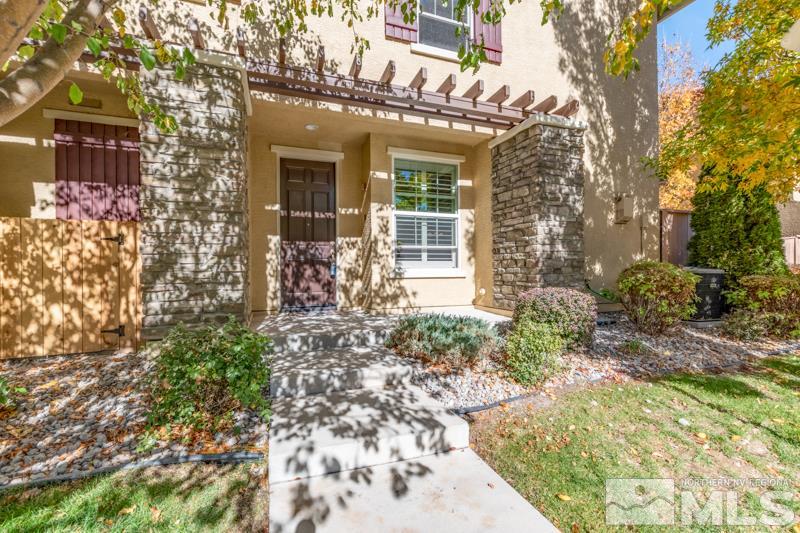 1925 Wind Ranch Road, Unit B Reno, NV 89521 - Photo 1 of 1 a front view of a house with garden
