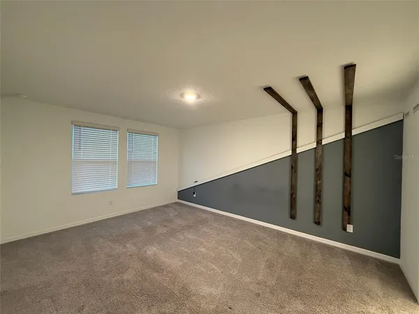 a view of an empty room with windows