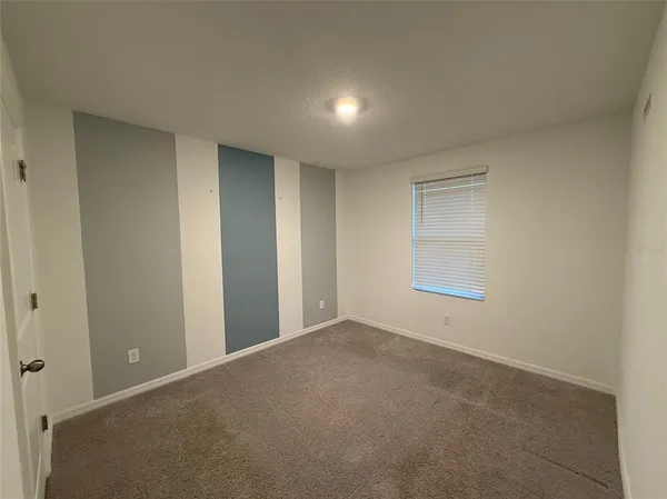 a view of an empty room and a window