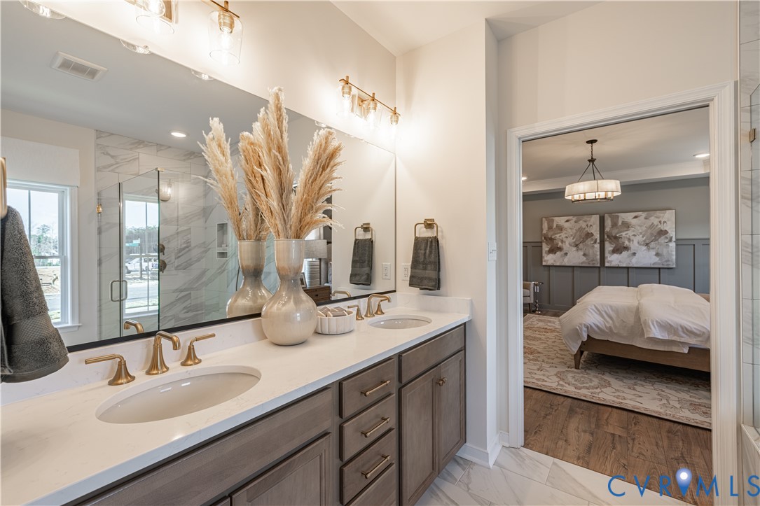 6710 Mayland Rdg Lane; Moseley, VA 23120 - Photo 11 of 16 a en suite bathroom with double sink and a mirror