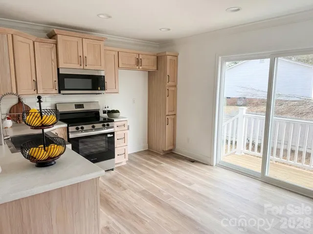 a kitchen with stainless steel appliances a stove a sink and a refrigerator