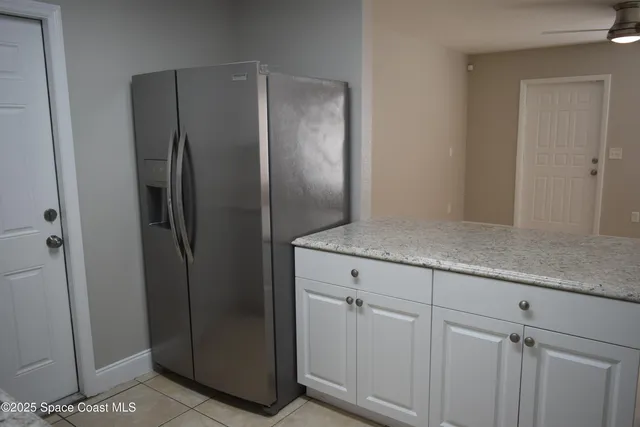 a kitchen with metallic refrigerator freezer and a dishwasher