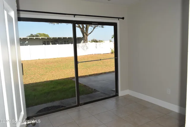 a view of a glass door with a yard from a window