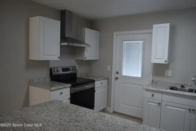 a kitchen with stainless steel appliances granite countertop a sink stove and cabinets