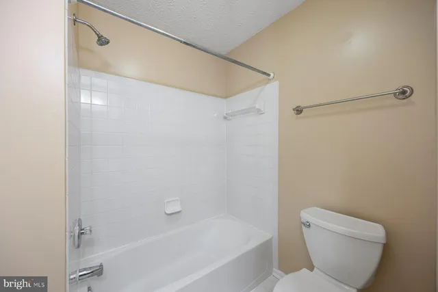 a bathroom with a toilet sink a mirror and vanity