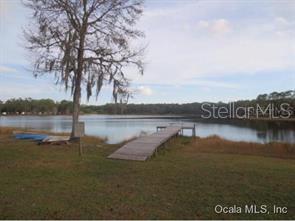 7th Loop Silver Springs, FL 34488 - Photo 3 of 10 a view of lake with houses