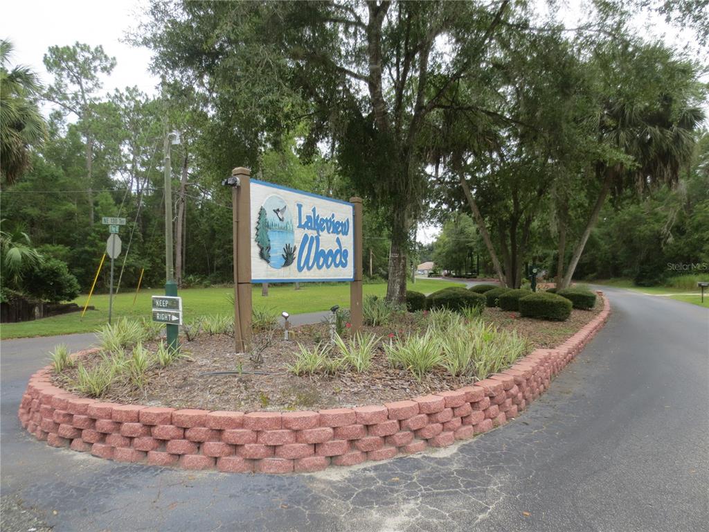 7th Loop Silver Springs, FL 34488 - Photo 6 of 10 a sign that is sitting on a wooden fence