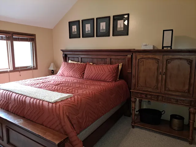 a bedroom with a bed and window