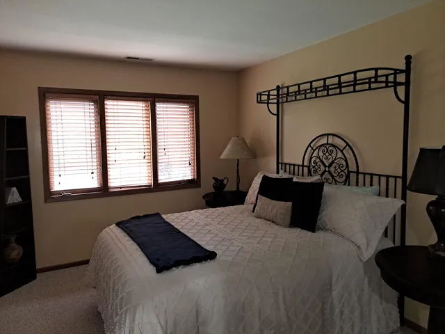 a bedroom with a bed and a window