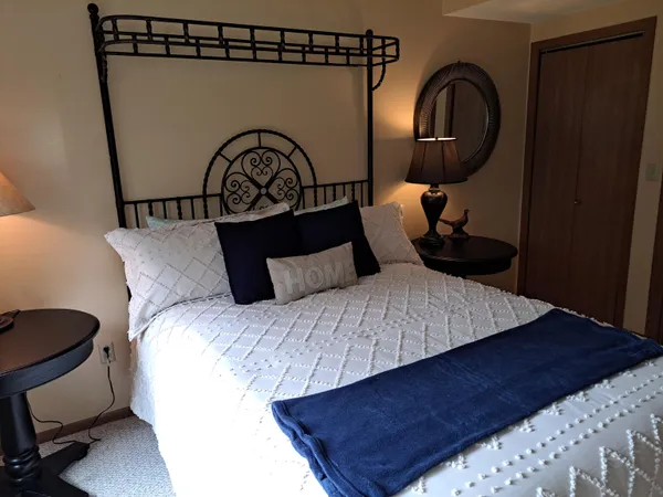 a bedroom with a bed and a dresser