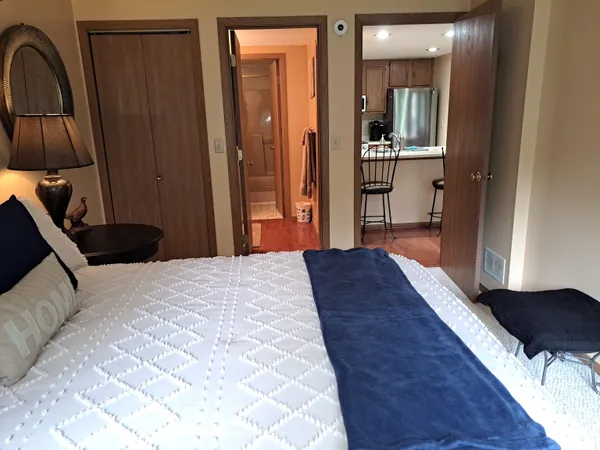 a bedroom with a bed and a mirror