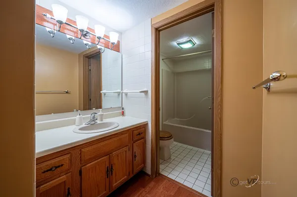 a bathroom with a shower sink and mirror