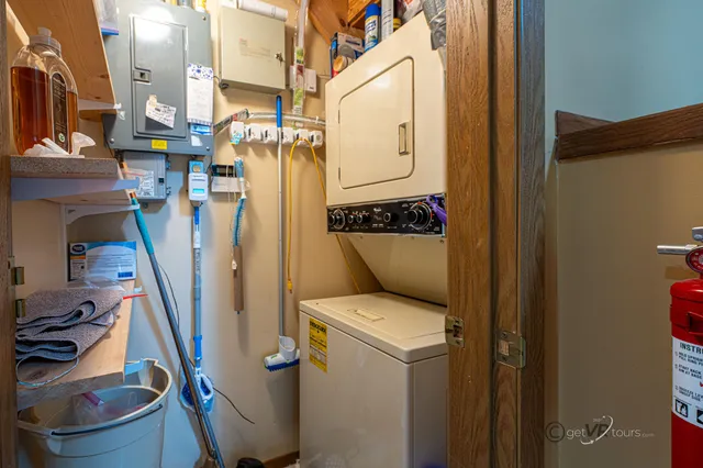 a utility room with dryer washer and a view of living room