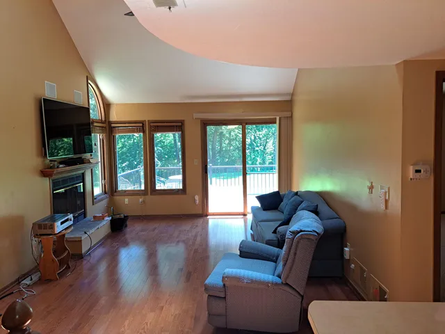 a living room with furniture and a wooden floor