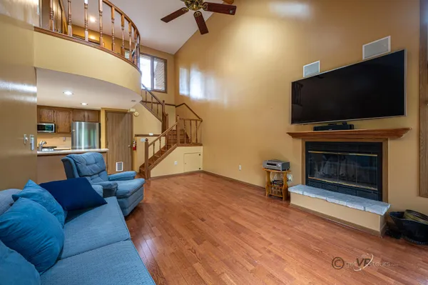 a view of staircase with wooden floor and windows